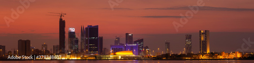 MANAMA , BAHRAIN - NOVEMBER 25: A panoramic view of Bahrain skyline with illuminated iconic buildings and dramatic hue in the sky on 25 November, 2019, Manama, Bahrain.