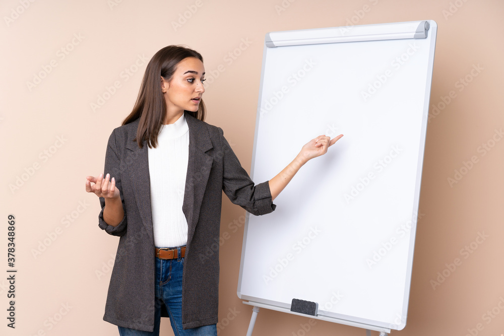 Young woman giving a presentation on white board giving a presentation on white board Young woman giving a presentation on white board giving a presentation on white board