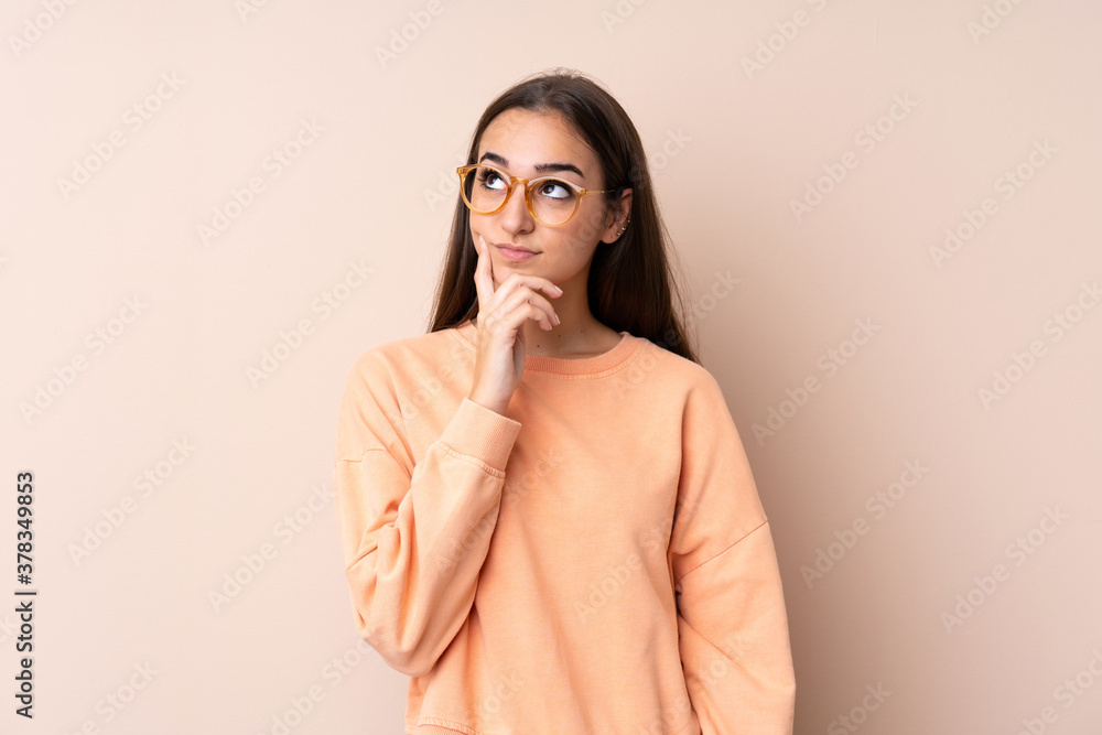 Young girl over isolated background thinking an idea Young girl over isolated background thinking an idea