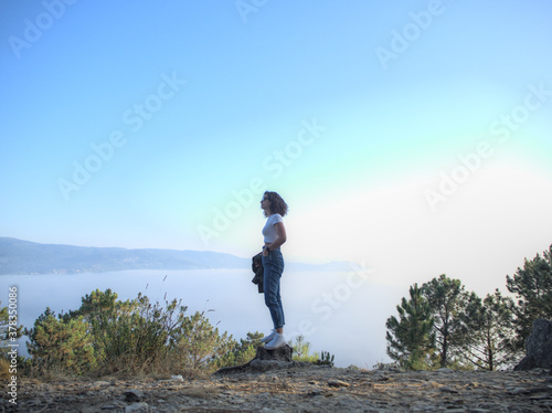 Girl in the forest with the sea in the background