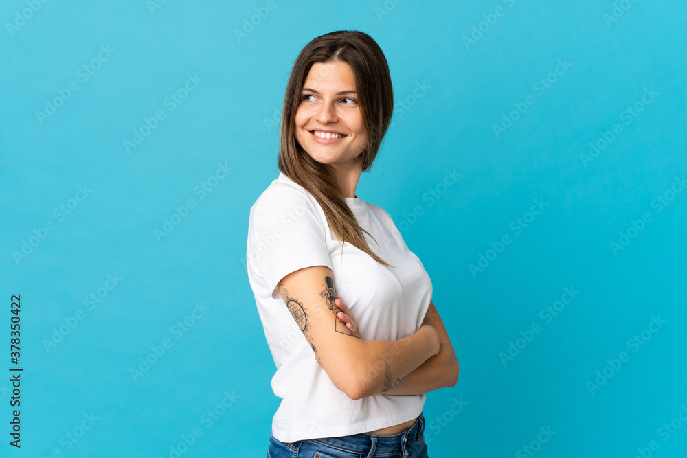 Young slovak woman isolated on blue background looking to the side and smiling Young slovak woman isolated on blue background looking to the side and smiling