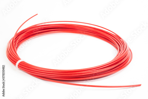 Top view of red rolled filament plastic for 3D Printing Pen isolated on white.