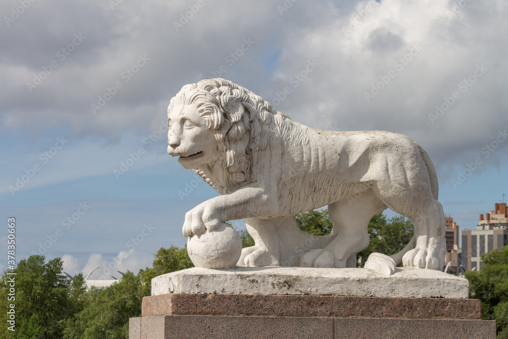 sculpture of a white lion with a ball sculpture of a white lion with a ball