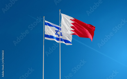 Bahrain and Israel Flags waving against a blue sky background. Bahrain–Israel signing historic diplomatic deal. Jerusalem and Manama relations 2020. 3D rendering