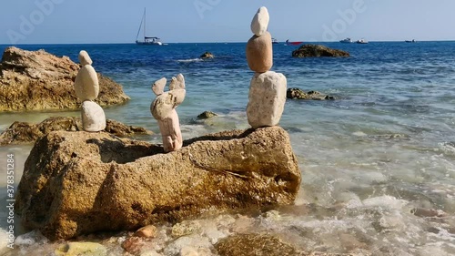 Sculptures on the beach with stones and pebbles