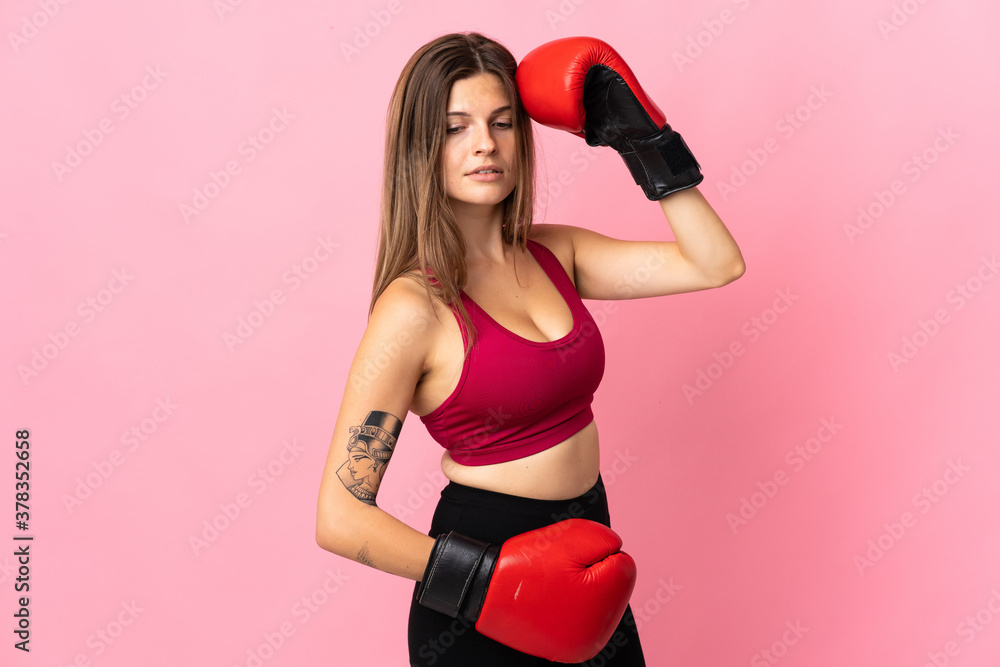 Young slovak woman isolated on pink background with boxing gloves