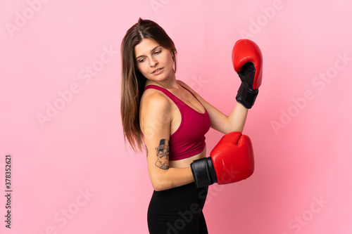 Young slovak woman isolated on pink background with boxing gloves