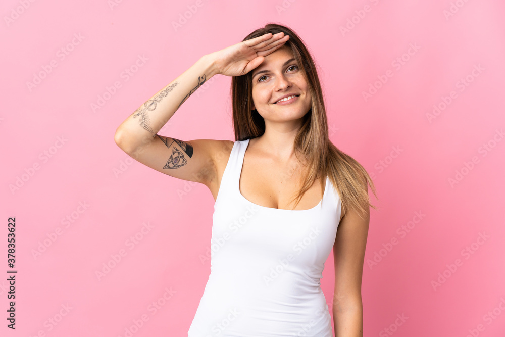 Young slovak woman isolated on pink background saluting with hand with happy expression Young slovak woman isolated on pink background saluting with hand with happy expression