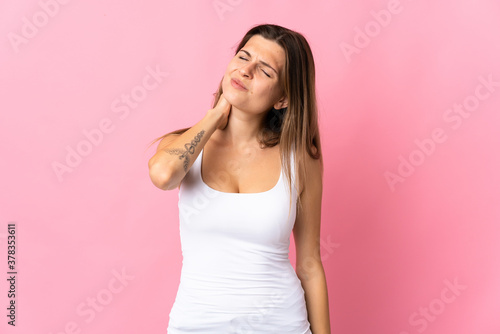 Young slovak woman isolated on pink background with neckache