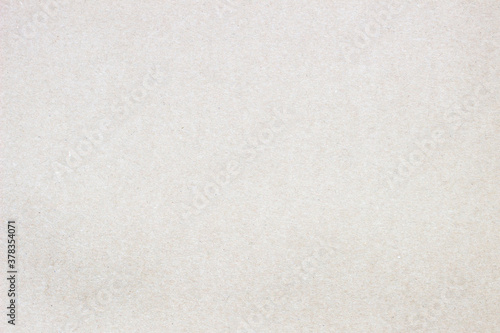 Smooth surface of a cardboard sheet of uniform texture.