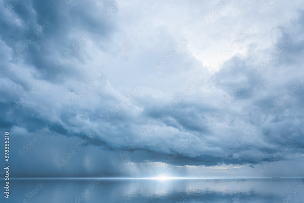 Dramatic blue sky at the sea with clouds reflection in water, Dark color, Ocean storm Dramatic blue sky at the sea with clouds reflection in water, Dark color, Ocean storm