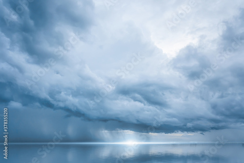 Dramatic blue sky at the sea with clouds reflection in water, Dark color, Ocean storm © enanuchit