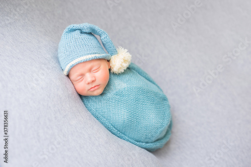Little baby. Newborn baby in the studio. A baby in a cloth wrap.
