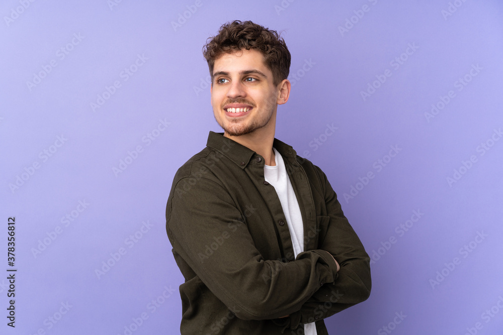 Caucasian man isolated on purple background with arms crossed and happy Caucasian man isolated on purple background with arms crossed and happy