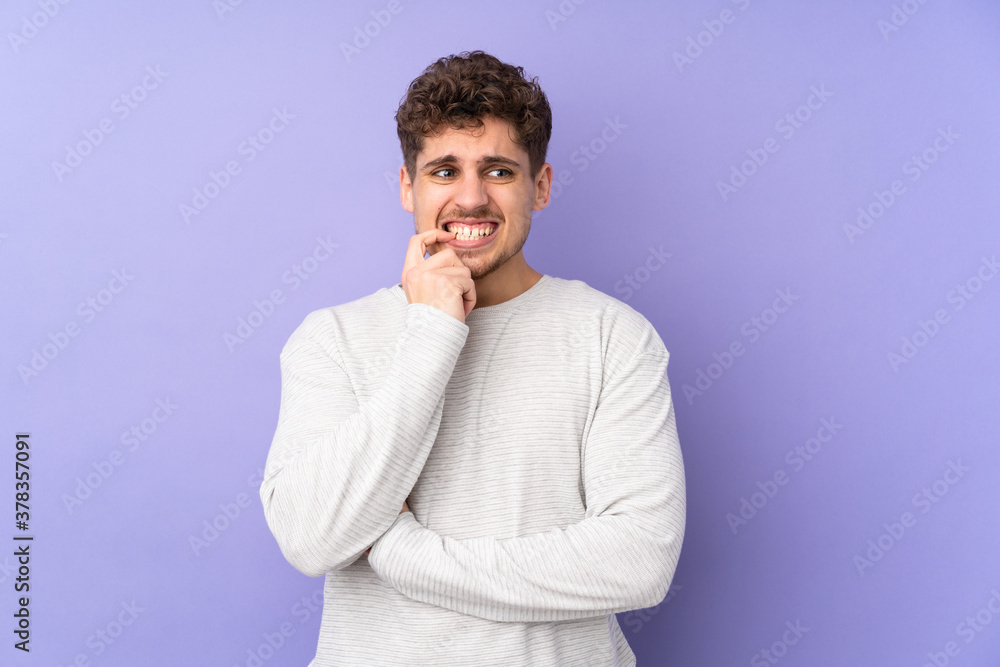Caucasian man isolated on purple background nervous and scared Caucasian man isolated on purple background nervous and scared