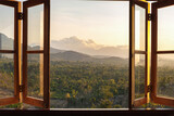 View from the window to the fields and mountains at sunset. View from the hotel window in the north of Bali