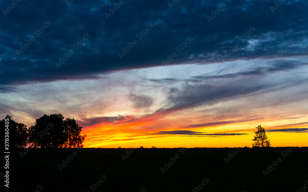 bright sunset over a field and a river in siberia bright sunset over a field and a river in siberia