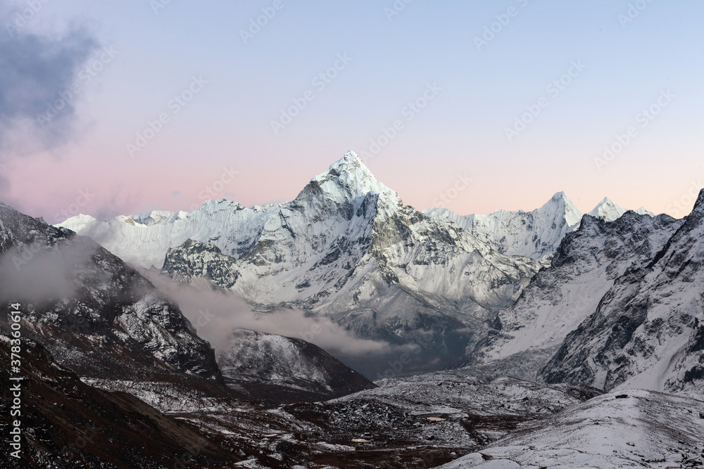 Amazing Mount Ama Dablam in Himalayas in mt Everest area, under Cho La pass. Pinkish sunset over high himalayan peak.