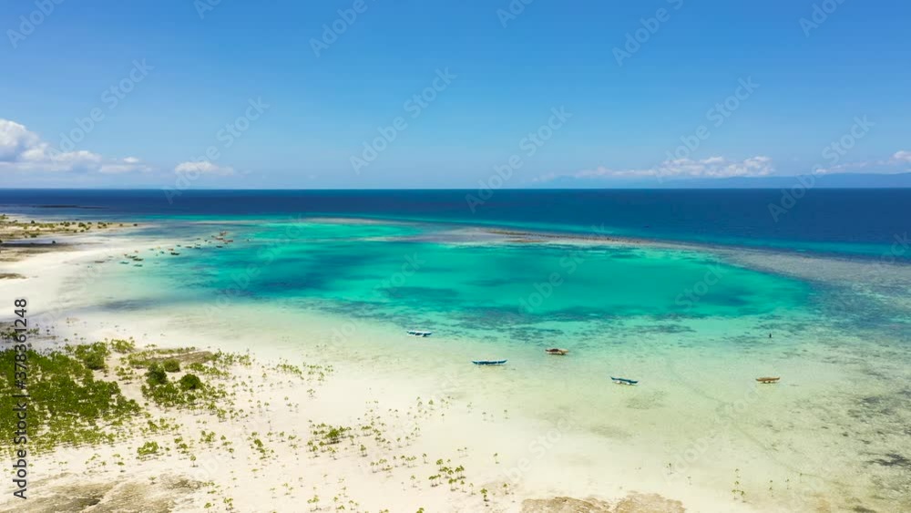 Top view of atoll with turquoise water and boats.Coral reef and blue sea. Coral reef and blue sea. Bohol,Philippines. Top view of atoll with turquoise water and boats.Coral reef and blue sea. Coral reef and blue sea. Bohol,Philippines.