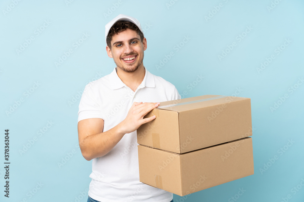 Delivery caucasian man isolated on blue background applauding Delivery caucasian man isolated on blue background applauding