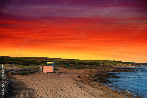 Rescue tower on the beach ay dramatic sunset © replica73