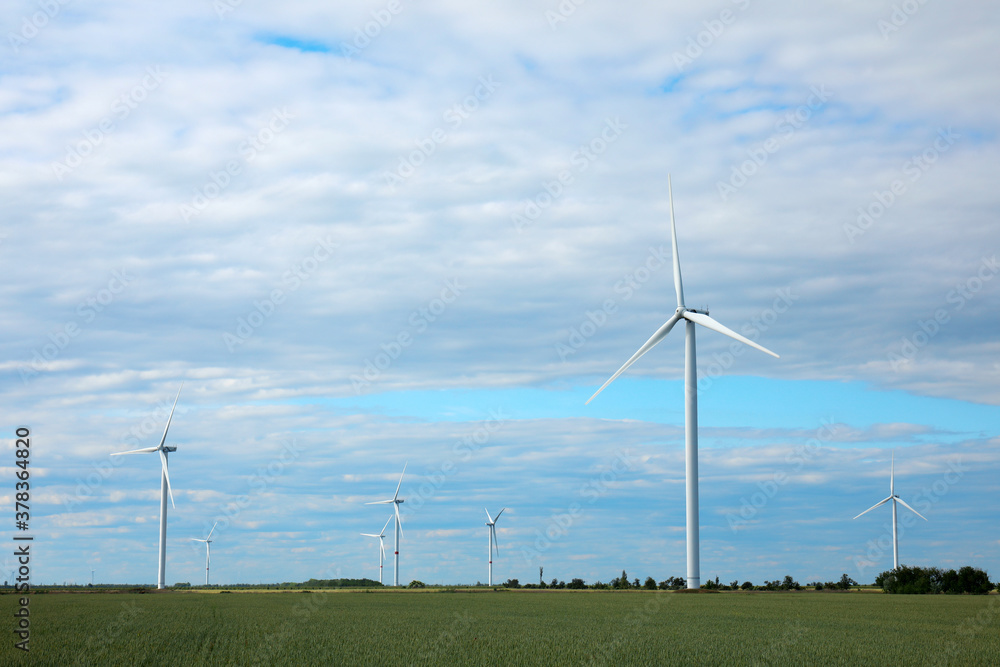 Beautiful view of field with wind turbines. Alternative energy source Beautiful view of field with wind turbines. Alternative energy source