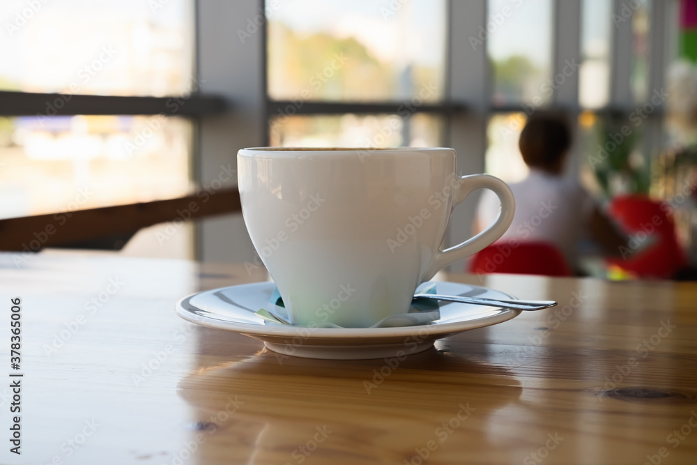 A cup of cappuccino on a table in a cafe. Morning coffee. A cup of cappuccino on a table in a cafe. Morning coffee.
