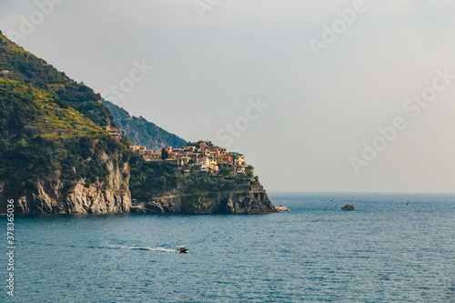 Lovely panoramic landscape view of Manarola, the second-smallest of the famous Cinque Terre towns. The small town with its colourful houses and vineyards on the cliff is a popular tourist attraction. © H-AB Photography