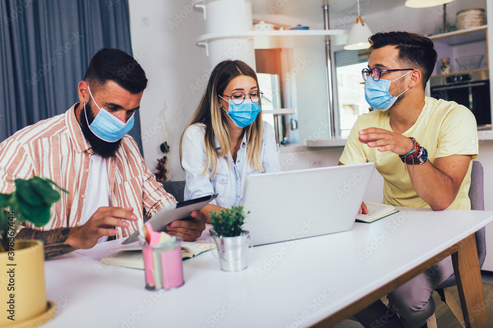 Students studies at home, wear protective masks, and using laptop Students studies at home, wear protective masks, and using laptop