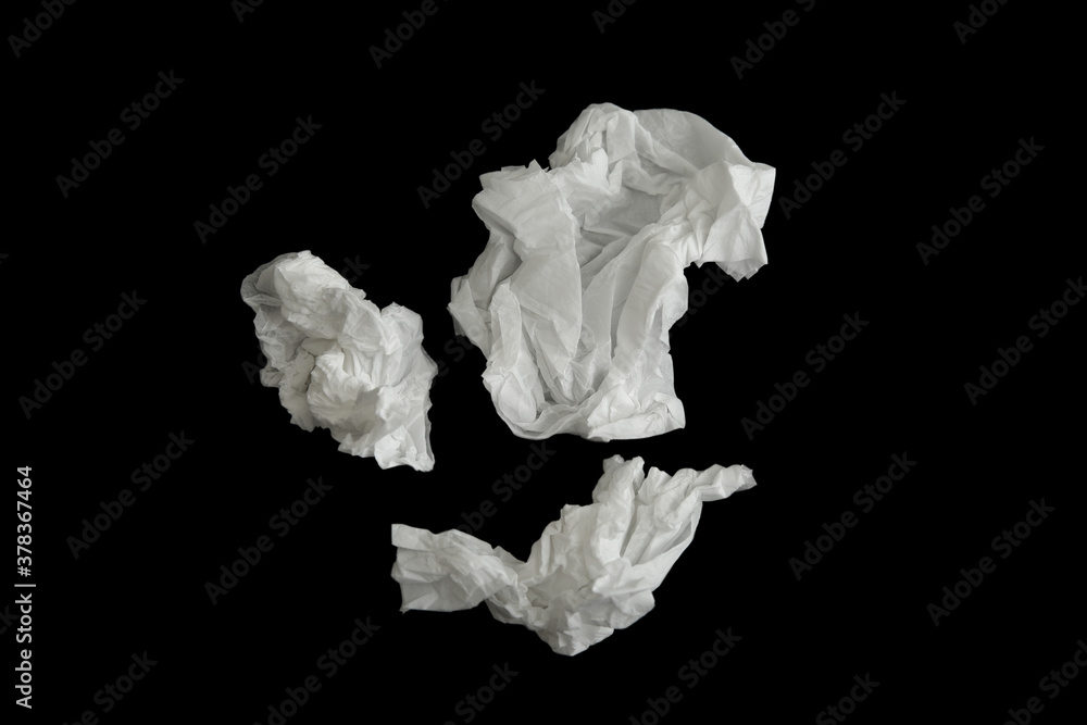 Used paper tissues on black background, flat lay