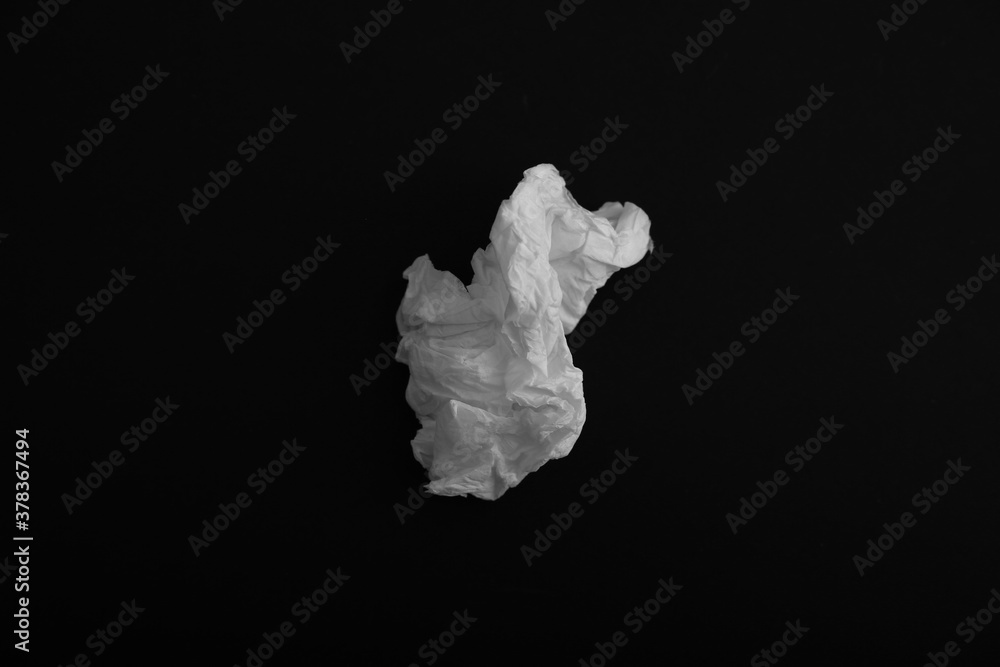 Used paper tissue on black background, top view Used paper tissue on black background, top view