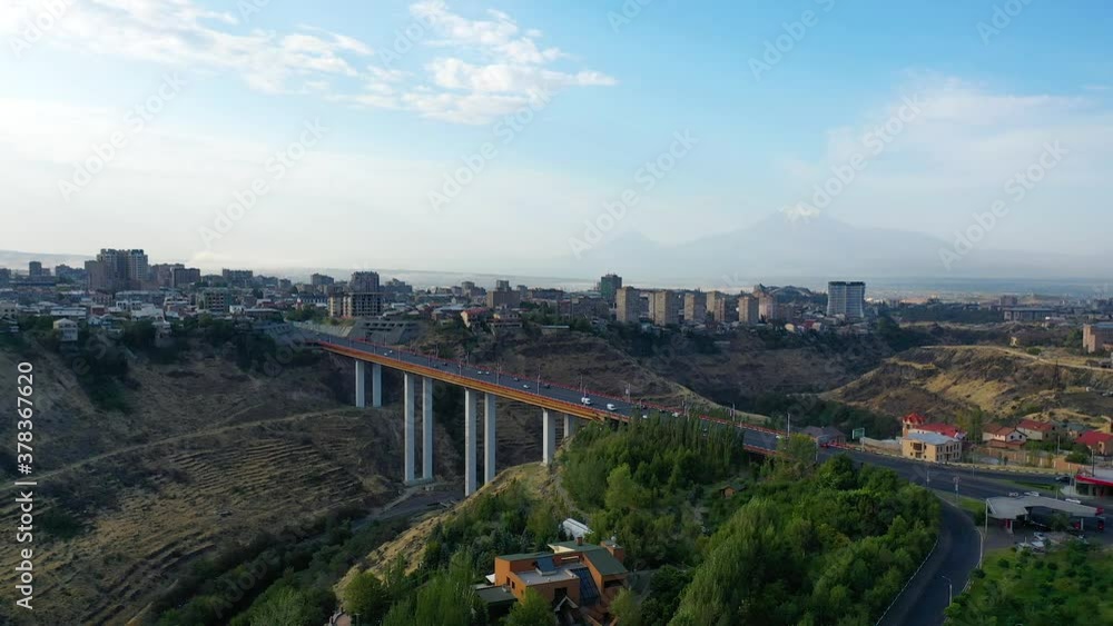 Aerial view bridge in Armenia.Active traffic in city, cars driving across (Davitashen) bridge.It is a bridge for traffic linking across the Hrazdan River in Yerevan. View on Ararat mountain. Aerial view bridge in Armenia.Active traffic in city, cars driving across (Davitashen) bridge.It is a bridge for traffic linking across the Hrazdan River in Yerevan. View on Ararat mountain.