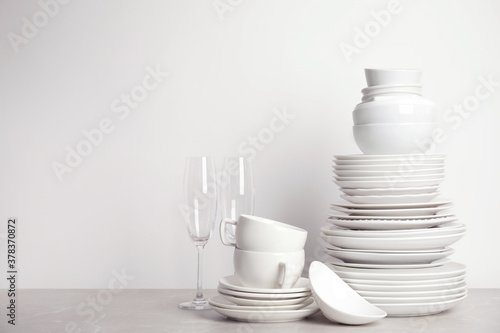 Set of clean tableware on white table