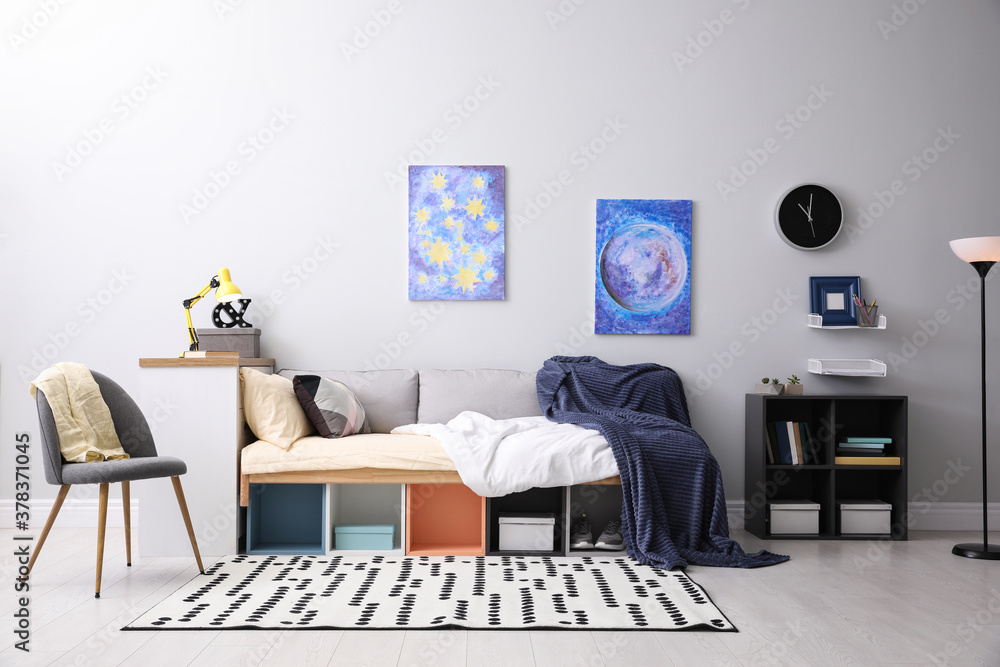 Fototapeta premium Modern teenager's room interior with comfortable bed and stylish design elements