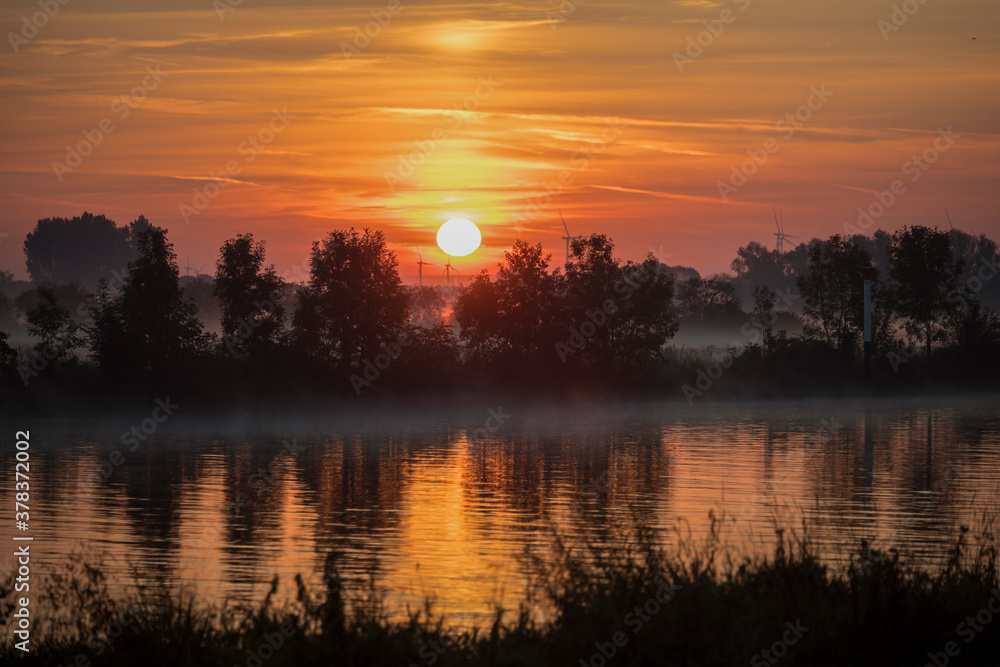 sunrise over the river maas in Holland