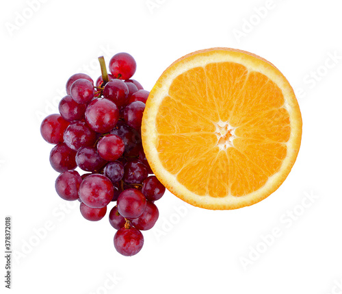 Red grapes and sliced oranges isolated on white background