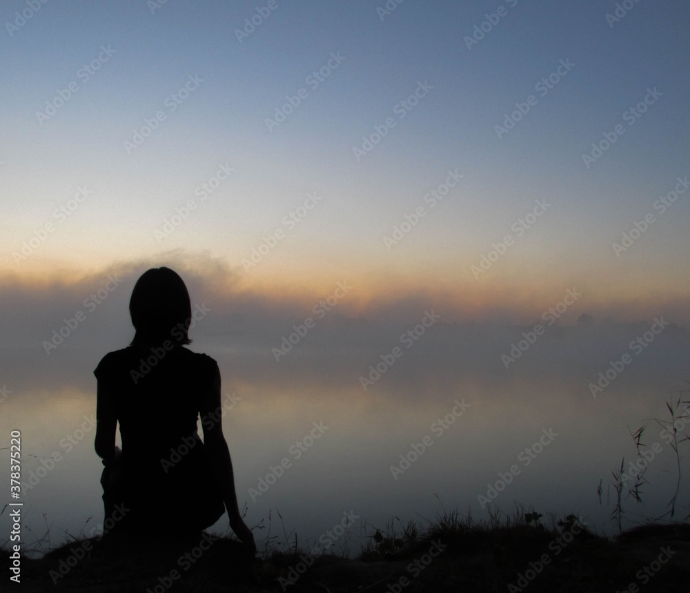 silhouette of person sitting on the ground silhouette of person sitting on the ground