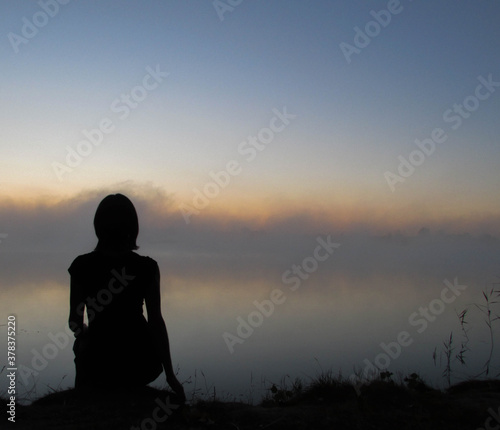 silhouette of person sitting on the ground