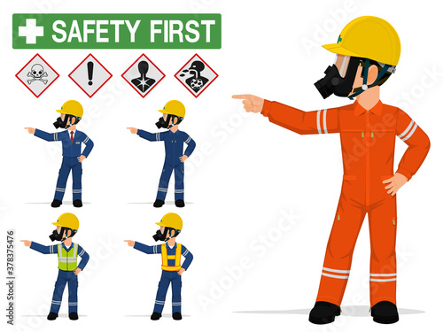 An industrial worker with respirator is pointing to something.