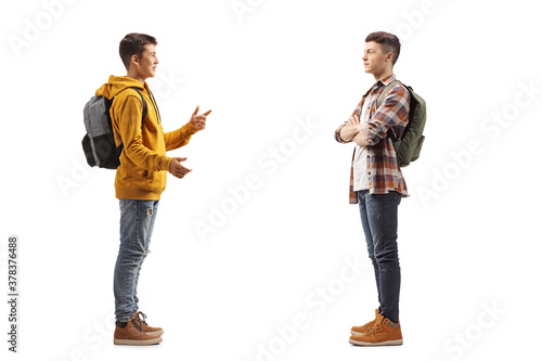 Full length profile shot of a two teenager boys having a conversation