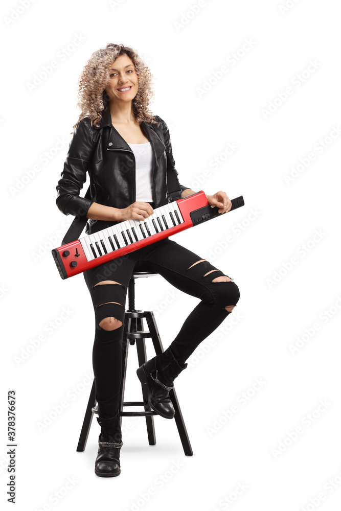 Portrait of a cool woman with a keytar synthesizer sitting on a chai Portrait of a cool woman with a keytar synthesizer sitting on a chai