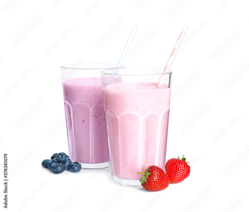 Different tasty milk shakes and berries isolated on white Different tasty milk shakes and berries isolated on white
