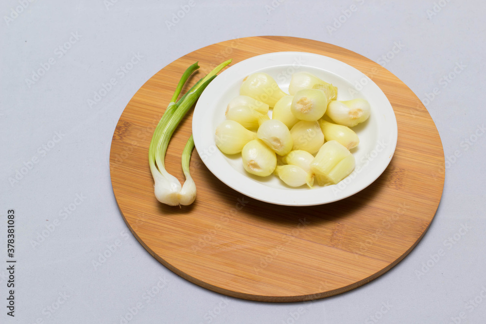 three pickled onions with parsley on white background three pickled onions with parsley on white background