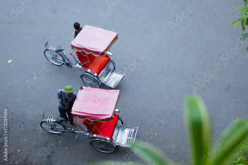 Traditional cyclo ride down the streets of Hanoi, Vietnam. The cyclo is a three-wheel bicycle taxi that appeared in Vietnam during the French colonial period.,September 19 2019