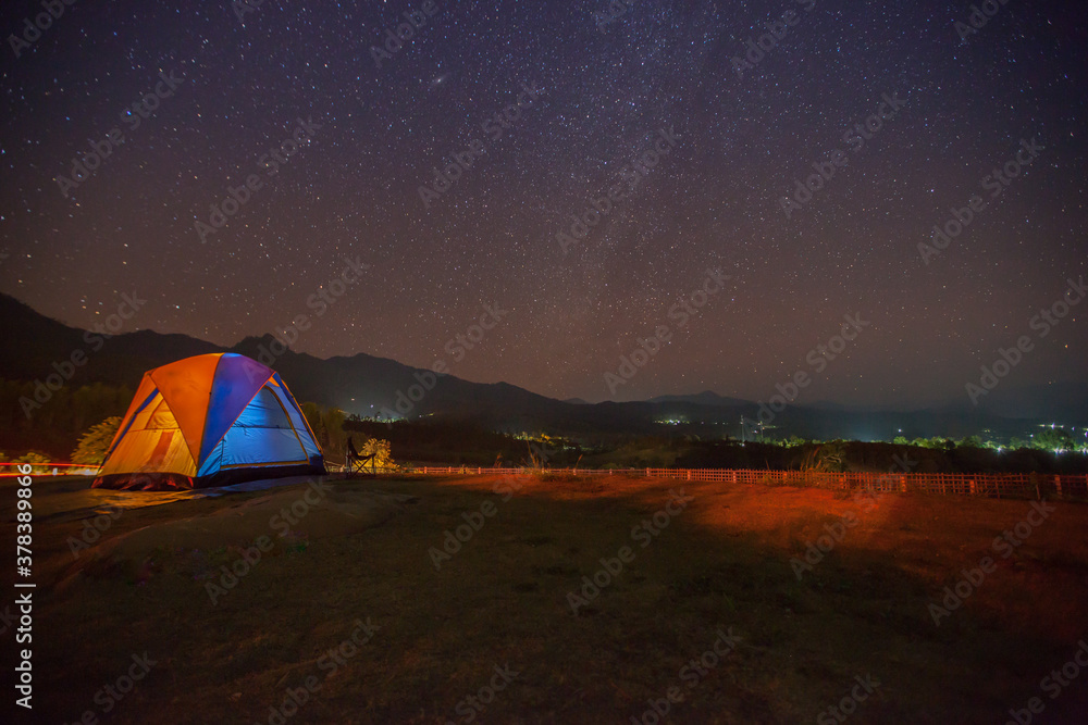 A star at nigh sky with cloudy with camping tents