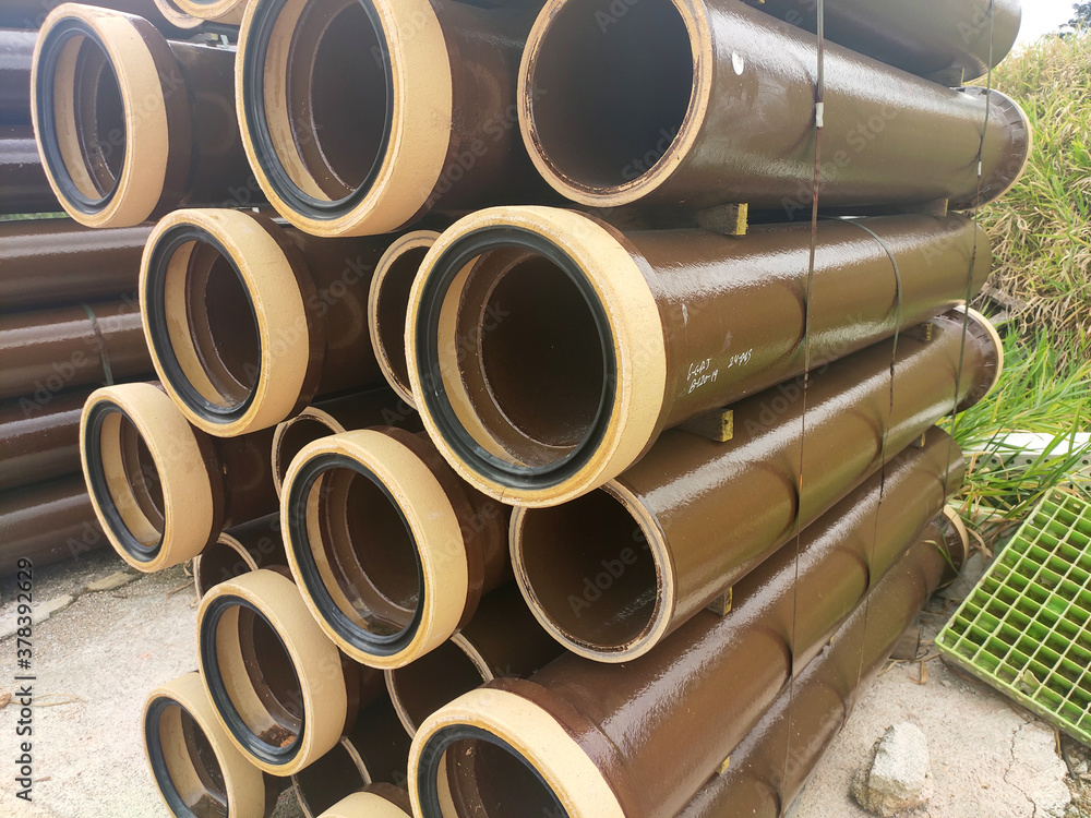 SEREMBAN, MALAYSIA -MARCH 2, 2020: Vitrified clay pipe stacked at the construction site. Commonly used as the sewerage underground pipe. It is lasting and heavy-duty. SEREMBAN, MALAYSIA -MARCH 2, 2020: Vitrified clay pipe stacked at the construction site. Commonly used as the sewerage underground pipe. It is lasting and heavy-duty.