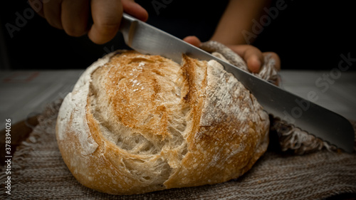 person slicing bread