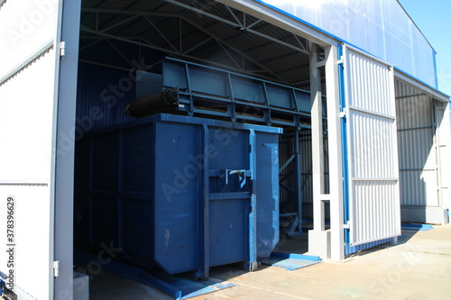 Blue waste containers in a large hangar