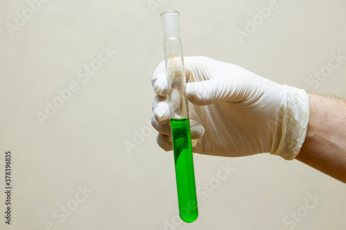 hand holding a test tube