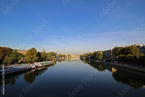 Seine river with tour boat at sunny summer sunrise, Paris, France.